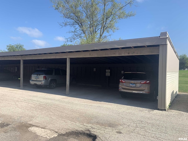 view of vehicle parking with a carport