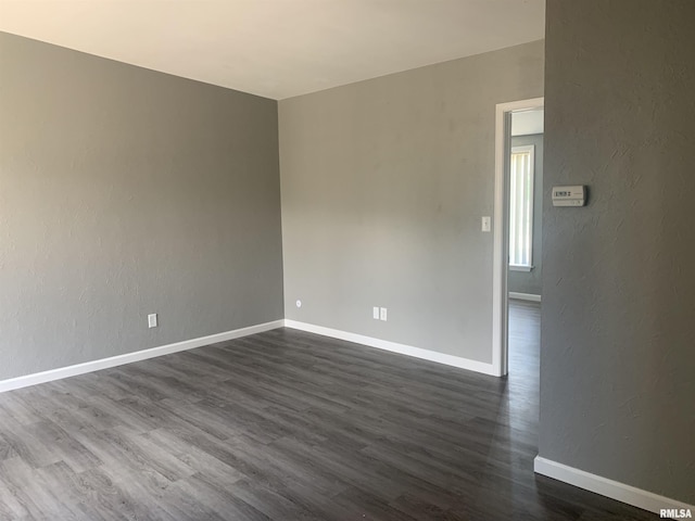 spare room featuring dark hardwood / wood-style floors