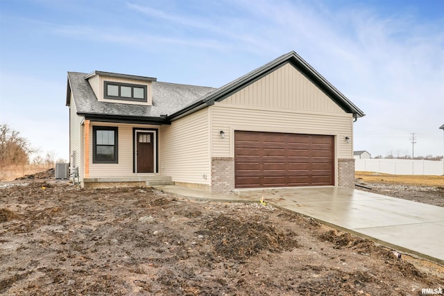 view of front facade featuring a garage and central AC