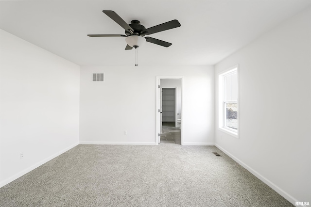 spare room with carpet flooring and ceiling fan