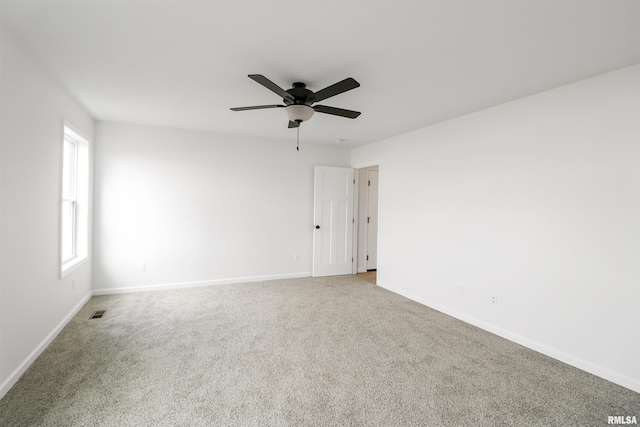 unfurnished room with ceiling fan and carpet flooring