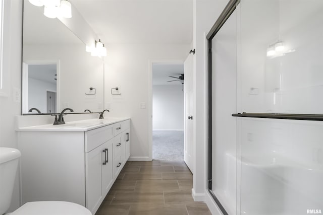 bathroom with vanity, a shower, and toilet