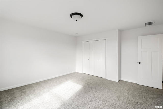 unfurnished bedroom featuring a closet and carpet