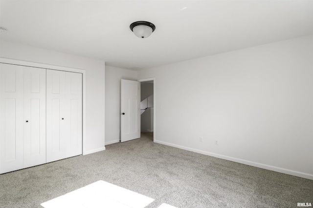 unfurnished bedroom featuring carpet floors and a closet