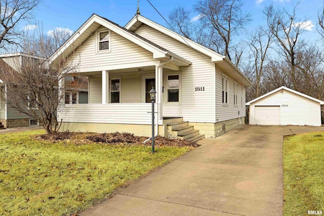 bungalow-style home featuring a garage, an outdoor structure, covered porch, and a front lawn