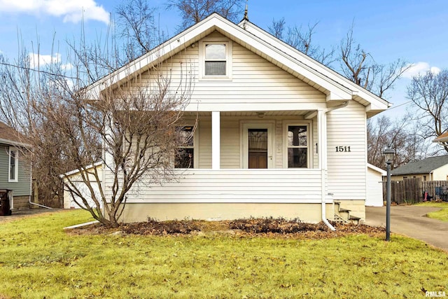 bungalow-style house featuring a porch and a front yard