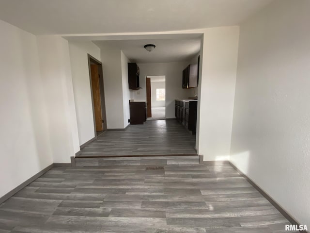 hallway with dark hardwood / wood-style flooring