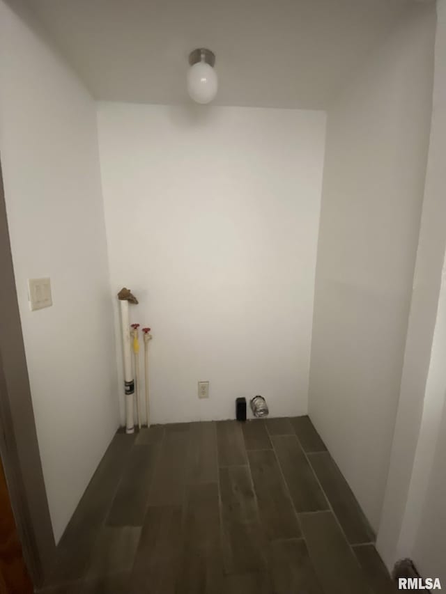 clothes washing area featuring dark hardwood / wood-style flooring