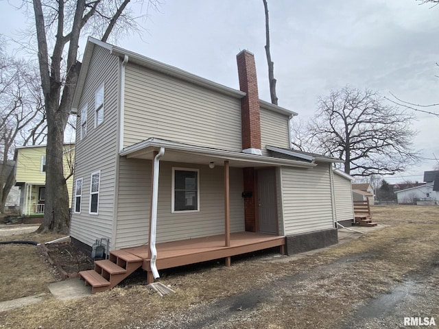 rear view of house with covered porch