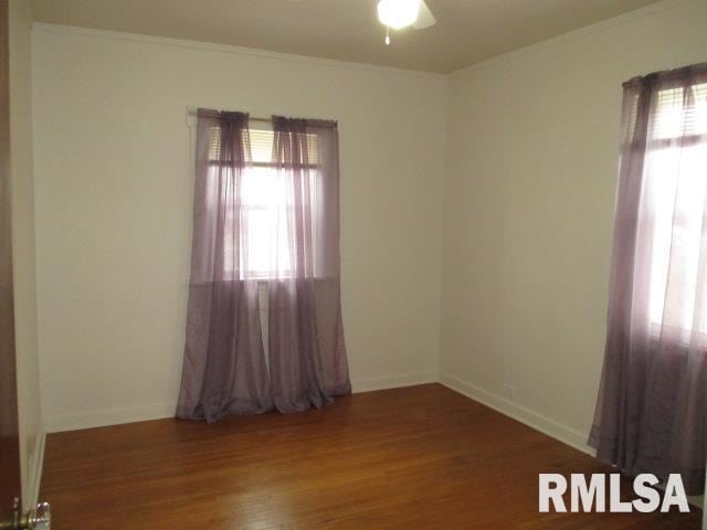 unfurnished room featuring ornamental molding, ceiling fan, and dark hardwood / wood-style flooring