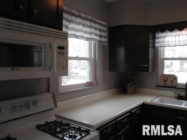 kitchen featuring sink and white appliances