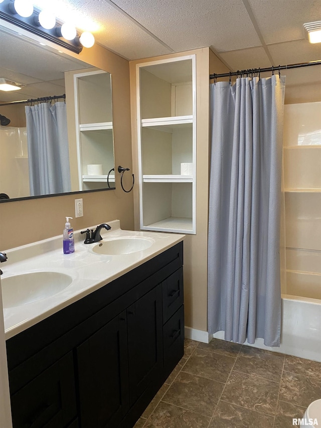 bathroom with vanity, a paneled ceiling, and shower / bath combination with curtain