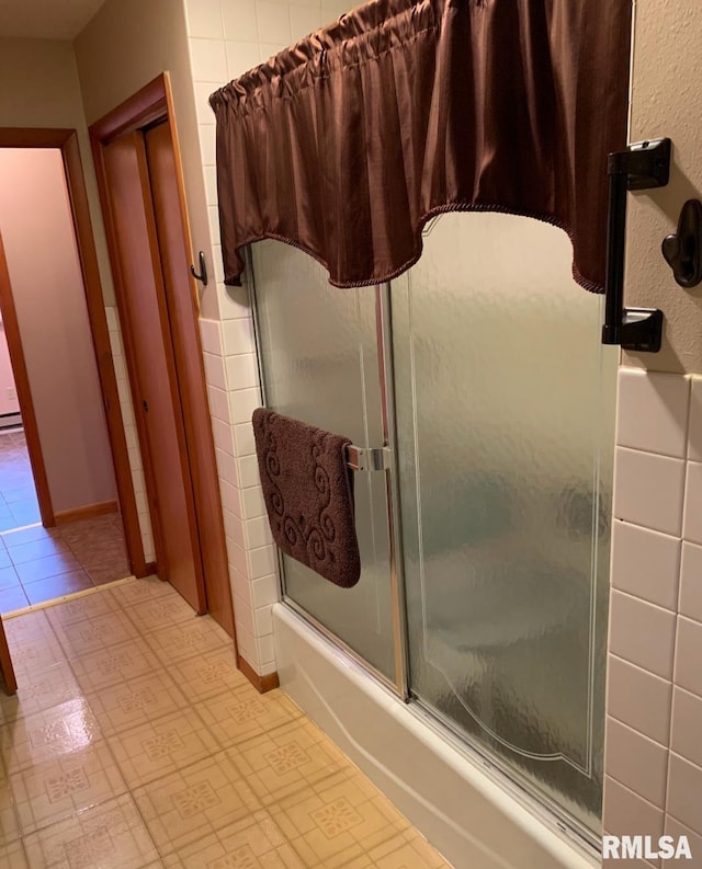 bathroom featuring tile patterned floors and combined bath / shower with glass door