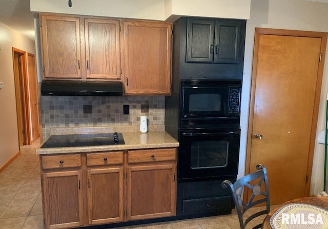 kitchen featuring backsplash, black appliances, and light tile patterned flooring