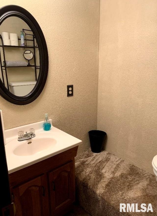 bathroom with vanity and toilet