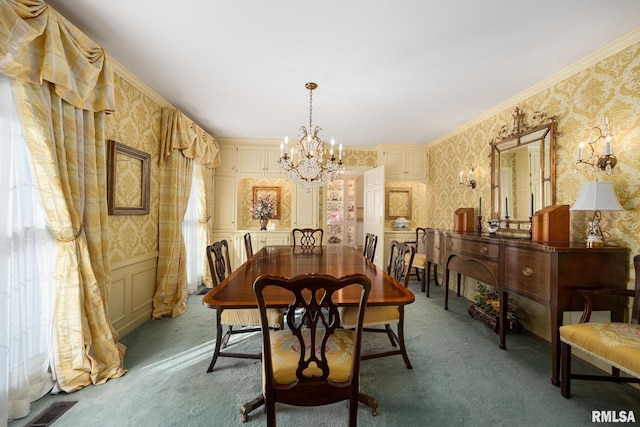 dining area featuring crown molding, carpet flooring, a wealth of natural light, and an inviting chandelier