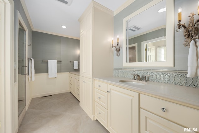 bathroom with tile patterned flooring, crown molding, vanity, and walk in shower