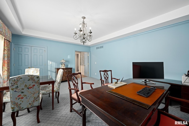 carpeted office space featuring a notable chandelier and a raised ceiling