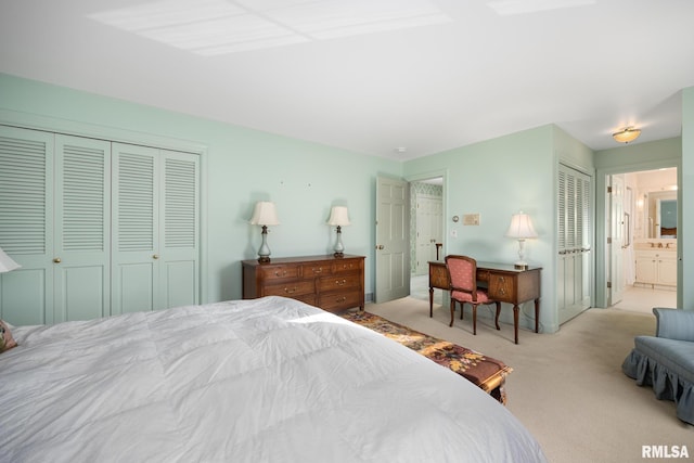 bedroom featuring light carpet, connected bathroom, and a closet