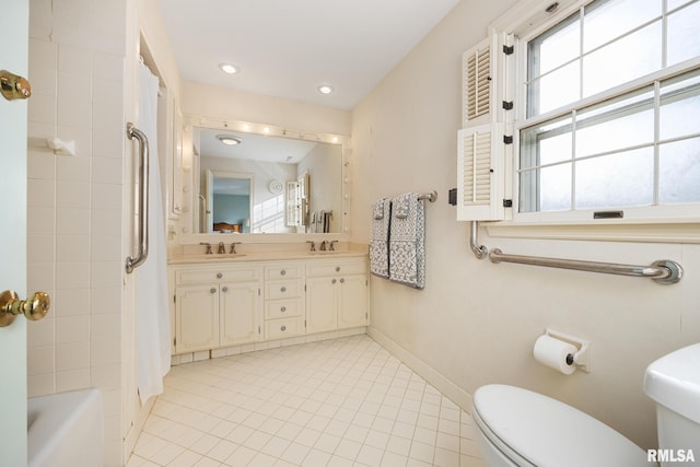 full bathroom with vanity, shower / bathtub combination with curtain, and toilet