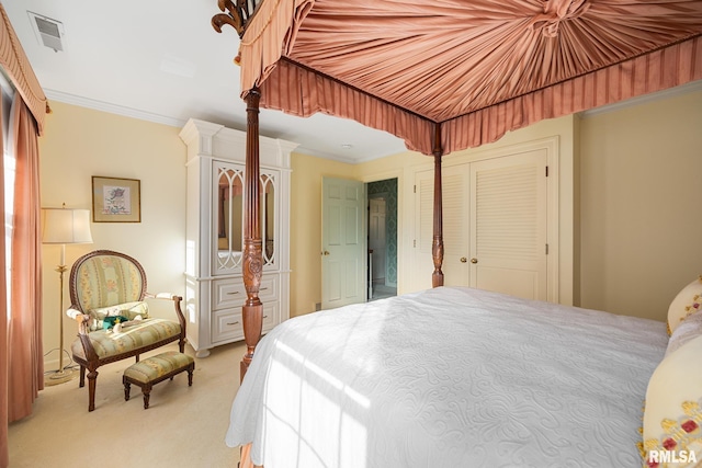 carpeted bedroom with crown molding and a closet