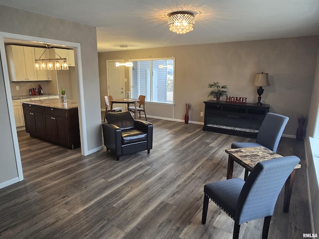 104 Parkway Dr, Carthage, IL 62321 - sitting room with a chandelier, dark wood-type flooring, and baseboards