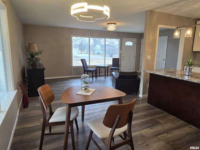 104 Parkway Dr, Carthage, IL 62321 - dining area featuring a chandelier, baseboards, and dark wood finished floors