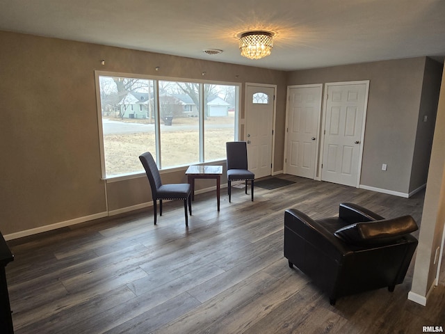 104 Parkway Dr, Carthage, IL 62321 - sitting room with baseboards, a chandelier, and dark wood-style floors