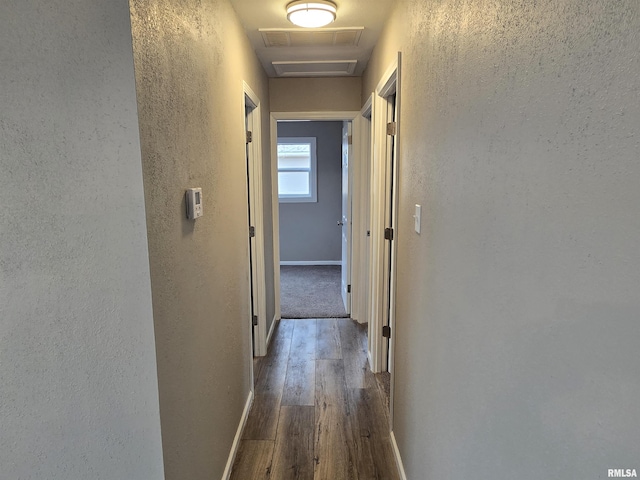 104 Parkway Dr, Carthage, IL 62321 - hallway featuring a textured wall, dark wood-style flooring, attic access, and baseboards