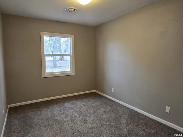 104 Parkway Dr, Carthage, IL 62321 - spare room featuring dark colored carpet and baseboards