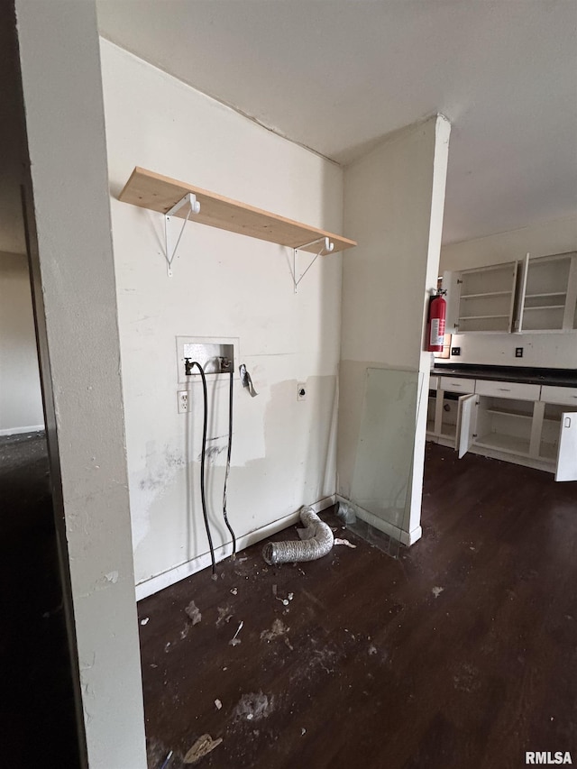 clothes washing area with dark hardwood / wood-style flooring