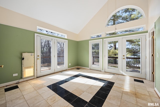 doorway to outside featuring light tile patterned flooring, high vaulted ceiling, and french doors