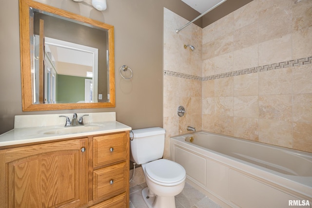 full bathroom featuring vanity, tiled shower / bath combo, and toilet