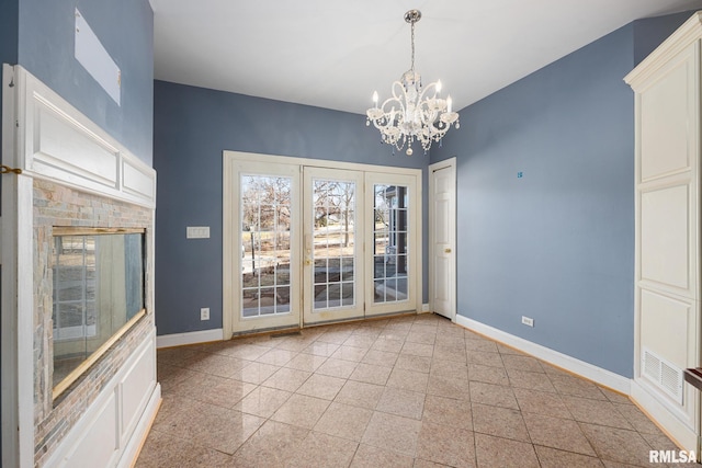 unfurnished dining area with a chandelier