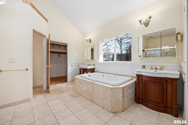 bathroom with tile patterned floors, lofted ceiling, plus walk in shower, and vanity