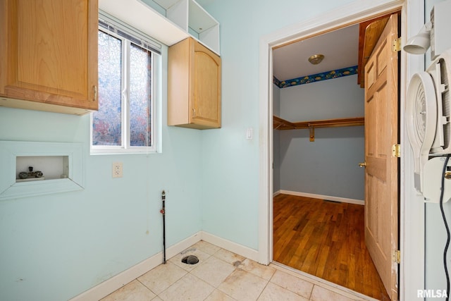 laundry room with light tile patterned flooring, cabinets, and hookup for a washing machine