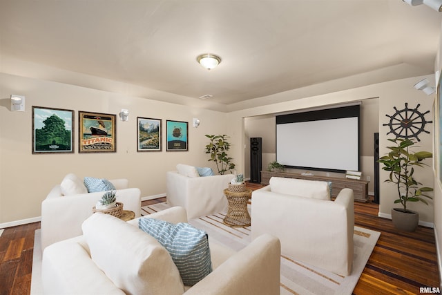 home theater room featuring dark wood-type flooring