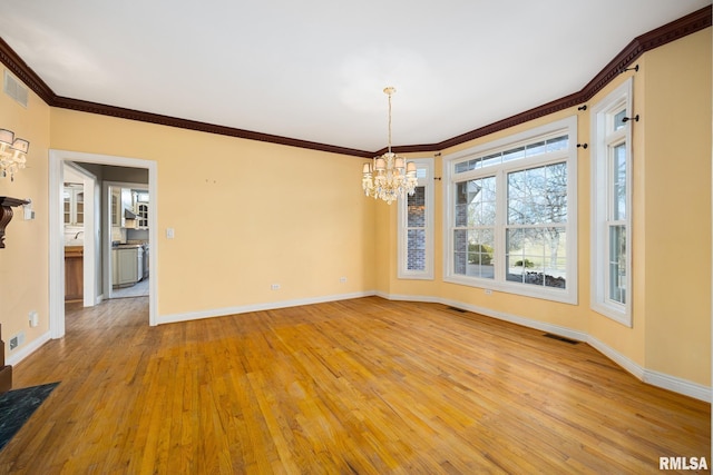 unfurnished dining area with an inviting chandelier, crown molding, and light hardwood / wood-style floors