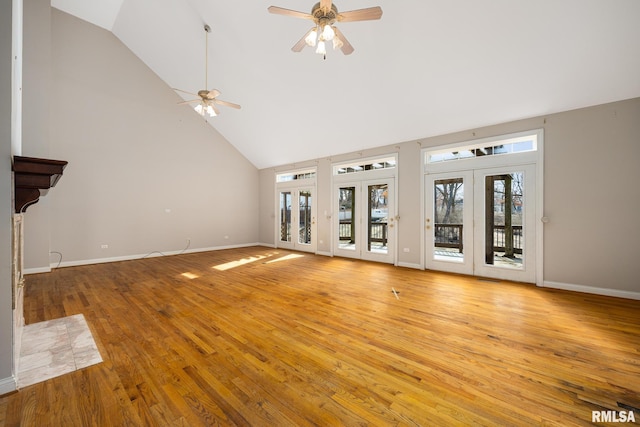 unfurnished living room featuring french doors, ceiling fan, high vaulted ceiling, and light hardwood / wood-style flooring