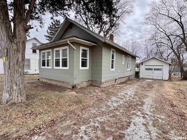 view of home's exterior featuring a garage and an outbuilding