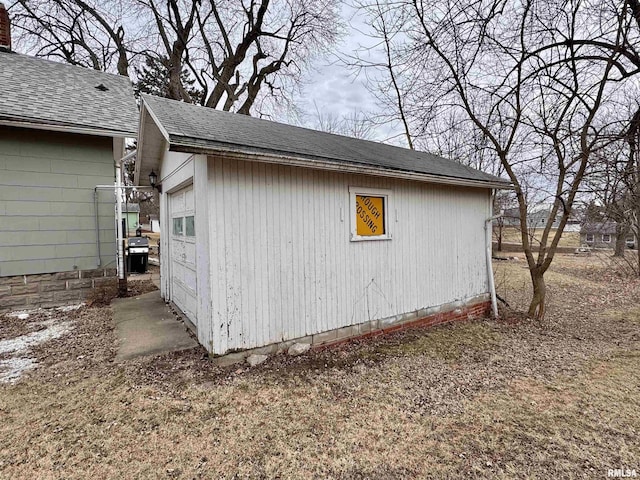 view of property exterior featuring a garage and an outdoor structure