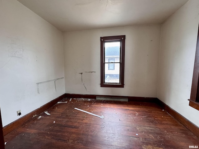 spare room featuring dark hardwood / wood-style floors