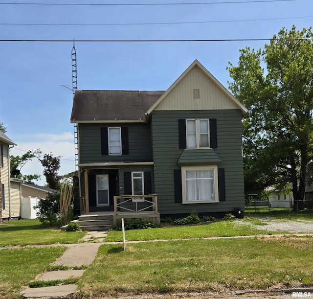 207 W Main St, La Harpe, IL 61450 - traditional-style home with a front yard and roof with shingles