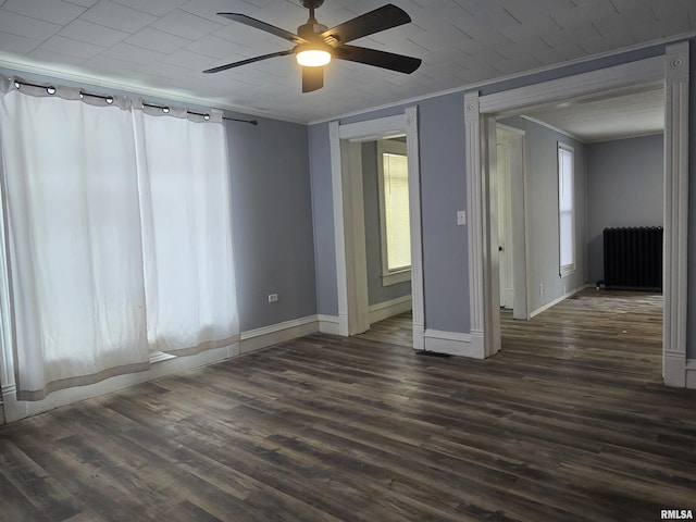 empty room featuring radiator, crown molding, dark hardwood / wood-style floors, and ceiling fan