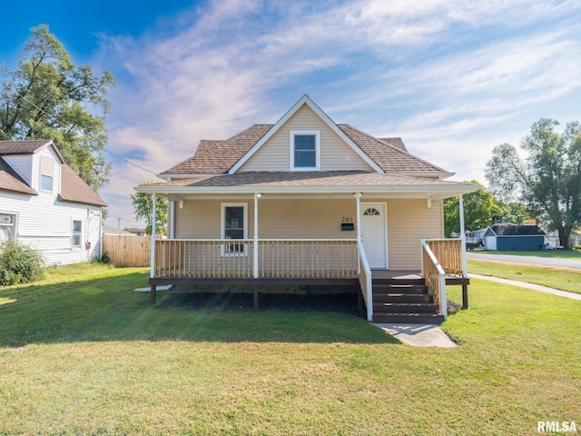 bungalow featuring a front yard and covered porch