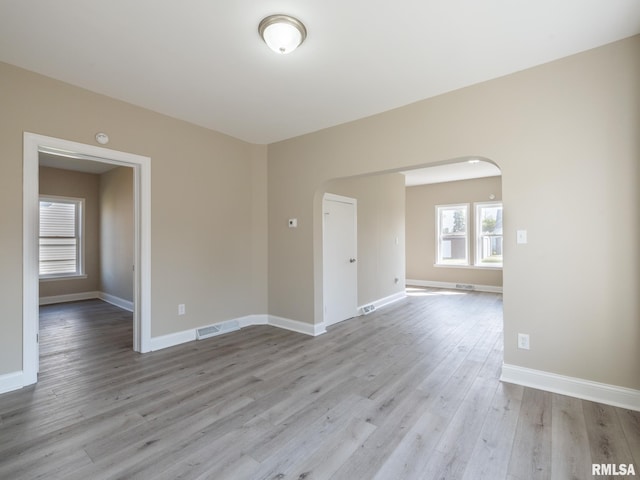 empty room with light hardwood / wood-style floors