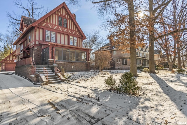 rear view of house featuring a sunroom