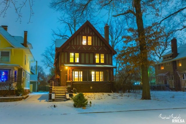 view of snow covered back of property