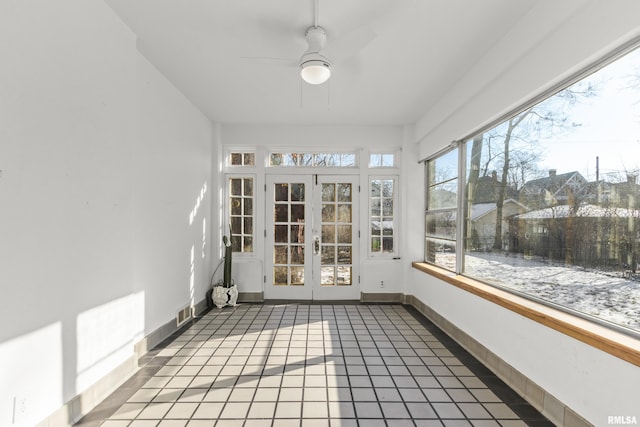 unfurnished sunroom with french doors and ceiling fan