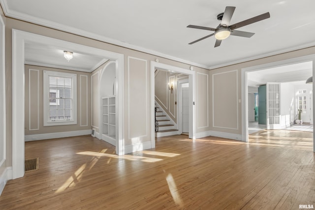 interior space featuring ornamental molding, ceiling fan, and light hardwood / wood-style flooring